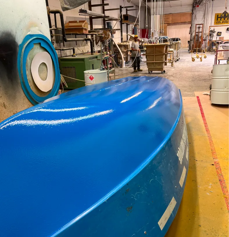 Coque de bateau en composite bleu brillant finie dans l'atelier de HTM Composites